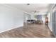 Open-concept living and dining area with wood floors, neutral walls, and built-in shelving at 1411 Cliff Ave, Eustis, FL 32726