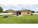 Backyard features a hot tub, retractable awning, outdoor seating, and well-maintained lawn at 1444 Daystar Ln, Deltona, FL 32725