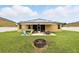 Backyard features a hot tub, retractable awning, outdoor seating, solar panels, and well-maintained lawn at 1444 Daystar Ln, Deltona, FL 32725