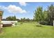 Backyard featuring a hot tub, outdoor seating, and a spacious lawn, perfect for outdoor enjoyment at 1444 Daystar Ln, Deltona, FL 32725