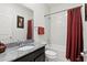 Bathroom featuring a granite countertop vanity, a shower-tub combo, and neutral colored accents at 1444 Daystar Ln, Deltona, FL 32725