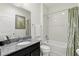 Bathroom featuring a granite countertop vanity and a shower-tub combo at 1444 Daystar Ln, Deltona, FL 32725