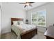 Well-lit bedroom with a ceiling fan, a cozy bed and scenic view from the window at 1444 Daystar Ln, Deltona, FL 32725