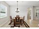 Dining room with natural light, modern chandelier, and elegant table setting at 1444 Daystar Ln, Deltona, FL 32725