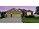Charming single-Gathering home featuring a two-car garage, stone accents and well-manicured lawn at 1444 Daystar Ln, Deltona, FL 32725