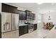 Gourmet kitchen featuring stainless steel appliances, dark cabinetry and mosaic tile backsplash at 1444 Daystar Ln, Deltona, FL 32725