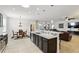 Open concept kitchen with island bar, seamlessly connecting to the dining and living areas at 1444 Daystar Ln, Deltona, FL 32725