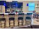 Modern kitchen featuring dark cabinets, granite countertops, stainless steel appliances, and barstool seating at 1444 Daystar Ln, Deltona, FL 32725