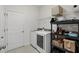 Bright laundry room with modern washer and dryer units and ample storage shelving at 1444 Daystar Ln, Deltona, FL 32725