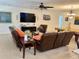 Living room featuring leather furniture, a large TV, neutral paint, and neutral tile flooring at 1444 Daystar Ln, Deltona, FL 32725