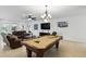 Expansive living room with a pool table, comfortable seating, and a large flat screen TV at 1444 Daystar Ln, Deltona, FL 32725
