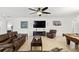 Bright, open-concept living area with tile flooring, a ceiling fan, and plenty of natural light at 1444 Daystar Ln, Deltona, FL 32725