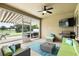 Covered patio with comfortable seating, outdoor TV, and a view of the backyard at 1444 Daystar Ln, Deltona, FL 32725