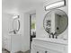 Modern bathroom with double vanities, black hardware, decorative mirrors, and tiled shower stall at 1518 Lakeside Dr, Deland, FL 32720