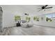 Bright, spacious bedroom with wood floors, two ceiling fans, and large windows overlooking the exterior at 1518 Lakeside Dr, Deland, FL 32720