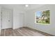 Neutral bedroom featuring a large window and wood-look vinyl floors at 1518 Lakeside Dr, Deland, FL 32720