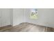 Simple bedroom with a window overlooking the yard and wood-look floors at 1518 Lakeside Dr, Deland, FL 32720