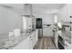 Modern kitchen featuring stainless steel appliances, granite countertops, and white cabinetry at 1518 Lakeside Dr, Deland, FL 32720