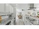 Spacious kitchen with granite countertops, stainless steel appliances, and open dining area at 1518 Lakeside Dr, Deland, FL 32720