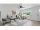 Bright living room featuring a large window, stylish furniture and modern ceiling fan at 1518 Lakeside Dr, Deland, FL 32720