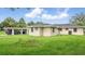 A view of the rear exterior reveals the car port and backyard at 1518 Lakeside Dr, Deland, FL 32720