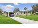 The home features a car port and a well-manicured lawn at 1518 Lakeside Dr, Deland, FL 32720