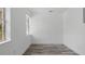 Small room with wood-look flooring, white walls, trim and ceiling, and a bright window at 1518 Lakeside Dr, Deland, FL 32720