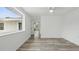 Bright room featuring wood-look flooring, white trim, walls, and ceiling, and a large window at 1518 Lakeside Dr, Deland, FL 32720