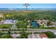 Community aerial view close to Sugar Mill Elementary School with a tranquil lake and cityscape in the distance at 152 Sweetgum Ln, Port Orange, FL 32129
