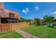 Beautiful backyard view of a home with a pond view and a wooden fence at 152 Sweetgum Ln, Port Orange, FL 32129