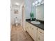 Bathroom is equipped with a tile floor, cabinet, mirror, lighting, and toilet at 152 Sweetgum Ln, Port Orange, FL 32129