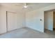 Bright bedroom includes a ceiling fan and closet with sliding doors at 152 Sweetgum Ln, Port Orange, FL 32129