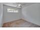 Simple bedroom provides a cozy retreat with soft carpet and a ceiling fan at 152 Sweetgum Ln, Port Orange, FL 32129