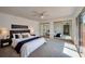 Bright bedroom with ceiling fan, mirrored closet doors, and access to porch at 152 Sweetgum Ln, Port Orange, FL 32129