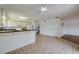 Well-lit kitchen with white cabinets, breakfast bar, and seamless flow into the living area at 152 Sweetgum Ln, Port Orange, FL 32129