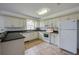 Bright kitchen featuring white cabinets, black granite countertops, and tile floors at 152 Sweetgum Ln, Port Orange, FL 32129