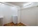 Spacious laundry room featuring washer, dryer and shelving at 152 Sweetgum Ln, Port Orange, FL 32129