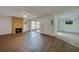Spacious living room with a brick fireplace and tile floors leading to a dining area at 152 Sweetgum Ln, Port Orange, FL 32129