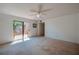 Open-concept living room with sliding glass door access to outdoor balcony at 152 Sweetgum Ln, Port Orange, FL 32129