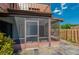 Screened patio with slate tile flooring, wood trim, and outdoor access at 152 Sweetgum Ln, Port Orange, FL 32129