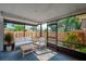 Screened porch with outdoor seating area, perfect for entertaining at 152 Sweetgum Ln, Port Orange, FL 32129