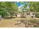 The fenced backyard features a cozy, tree-shaded space great for outdoor enjoyment and activities at 1610 Brady Dr, Deltona, FL 32725