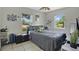 Cozy bedroom with two windows, tile flooring, neutral walls, and ceiling fan at 1610 Brady Dr, Deltona, FL 32725