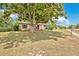 Charming single-story home with a walkway leading up to a covered porch, shaded by a large tree at 1610 Brady Dr, Deltona, FL 32725