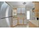 Bright kitchen featuring white cabinets, stainless steel appliances, tile floors, and natural light at 1610 Brady Dr, Deltona, FL 32725