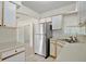Bright kitchen with white cabinets, stainless steel appliances, tile floors, and natural light at 1610 Brady Dr, Deltona, FL 32725
