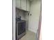 This laundry room is equipped with overhead cabinets and a modern, stainless steel washing machine at 1610 Brady Dr, Deltona, FL 32725