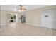 Living room featuring tile floors, ceiling fan, white walls, and an open layout with access to the kitchen at 1610 Brady Dr, Deltona, FL 32725