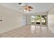 Spacious living room with tile flooring, ceiling fan and natural light from the large windows at 1610 Brady Dr, Deltona, FL 32725