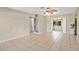 Large living room with tile floors, ceiling fan, and an open doorway, bathed in natural light at 1610 Brady Dr, Deltona, FL 32725
